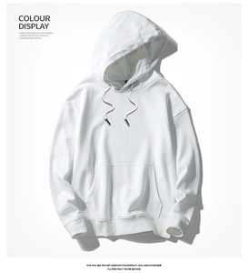 Detail of white cotton hoodie showing drawstring hood and kangaroo pocket texture