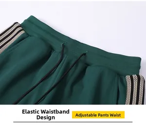 Detail of elastic waistband with black drawstring on dark green striped sports pants