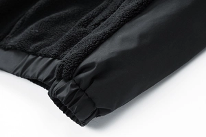 Detail shot of the black fleece lining and elastic cuff on this warm men's jacket