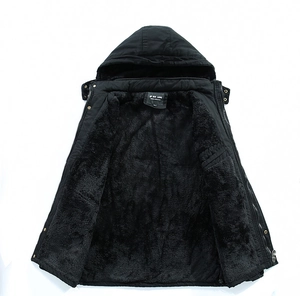 Detail view of men's black parka showing thick faux fur lining and warm hooded design