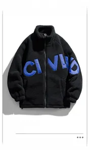 Close-up of black sherpa fleece jacket featuring blue CI VUD applique embroidery