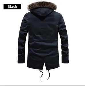 Close-up detail of a black winter parka for men featuring a thick fur collar and drawstring hem