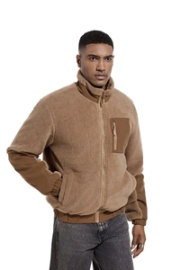 Detailed close-up of khaki sherpa fleece jacket featuring nylon trim on high collar and zipper