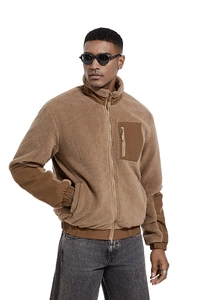 Detail of camel sherpa fleece jacket featuring windproof stand collar and chest zip pocket