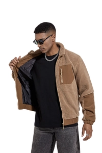 Close-up of brown sherpa fleece jacket with reinforced pocket and smooth inner lining