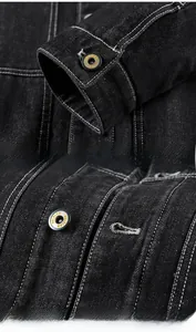 Détails d'une veste en jean noire avec coutures blanches et boutons métalliques