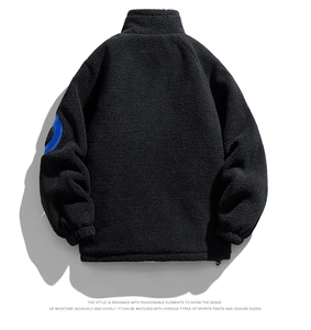 Rear view of black polar fleece jacket with blue geometric patch on left sleeve