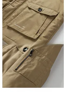 Detail view of khaki heavy cotton parka with multi-pocket design and metallic sleeve zipper