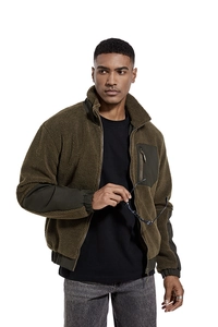 Detailed close-up of olive green fleece jacket with windproof fabric stitching details