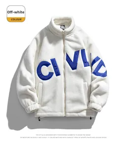 Detailed view of cream-white sherpa jacket with blue letter embroidery and silver zipper