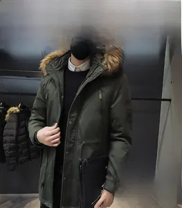 Detail of army green winter parka with plush fur collar and functional cargo pockets
