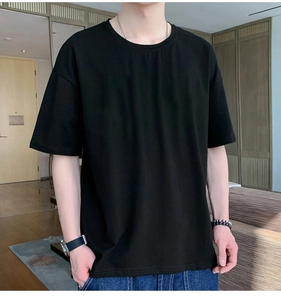 Detail of oversized black cotton T-shirt featuring a relaxed fit and dropped shoulders