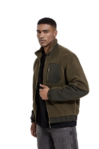 Detail of army green sherpa jacket with nylon chest pocket and stand collar