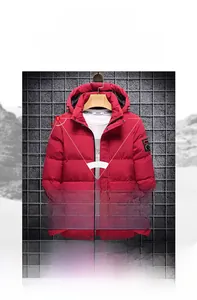 Detail of red hooded winter puffer jacket with windproof fabric and arm patch