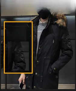 Close-up of men's winter parka featuring windproof fabric and a detachable faux fur collar