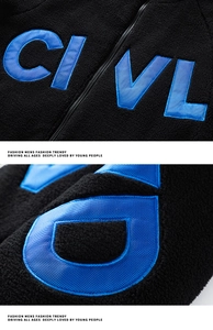 Detail of blue letter embroidery on black sherpa fleece jacket with modern stitching