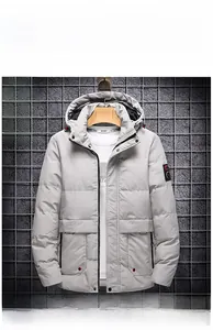 Detail view of khaki padded hooded winter jacket with multi-pocket design on mesh wall