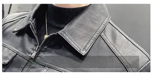 Detail view of premium black PU leather jacket shoulder with reinforced stitching and soft texture
