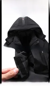 Detail showing the adjustable velcro cuff and hood neckline of the men's winter jacket