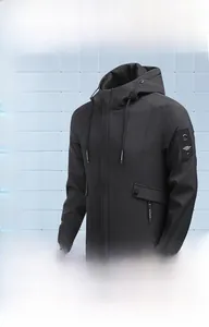 Detail view of black hooded jacket featuring drawstrings, zipper closure and sleeve patch