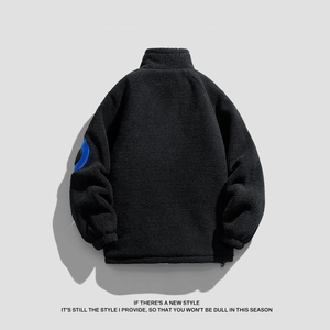 Black fleece jacket for men with high collar and blue patch detail on sleeve back view