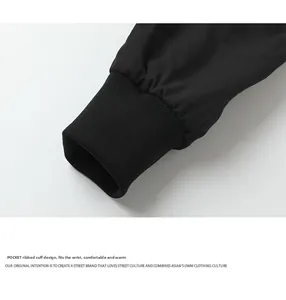 Detail of ribbed elastic cuffs on a black technical flight jacket with windproof design