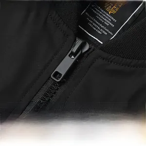 Detail of matte black metal zipper and ribbed knit collar on technical flight jacket