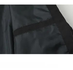 Macro detail showing the inner pocket stitching on a black technical flight jacket
