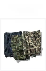 Flat lay of cargo shorts in navy, army green, and khaki with drawstring waist