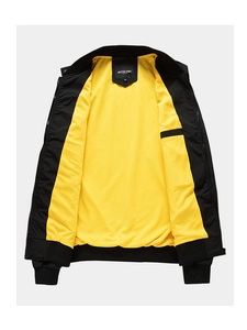 Detail of black jacket with yellow mesh lining, zipper, and ribbed cuffs and collar