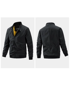 Detail of men's black bomber jacket with contrasting yellow lining and ribbed cuffs