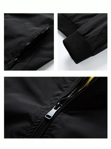 Detail of men's black jacket featuring yellow lining, ribbed cuffs and metal zipper pockets