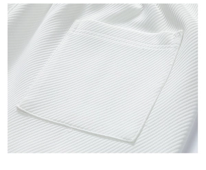 Close-up of white waffle texture fabric and premium stitching on pocket detail