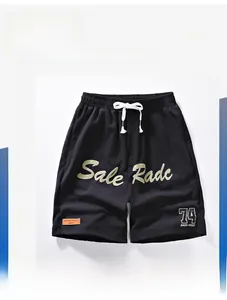 Detail of black shorts featuring NASA logo print and orange embroidery on quick-dry fabric