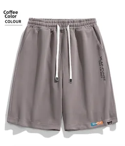Detail of coffee brown waffle knit shorts featuring a drawstring waist and sample patch