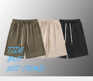 Detail of three men's casual shorts in olive, beige, and black with elastic drawstrings