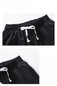 Detail of men's black ice silk shorts showing elastic waist with white drawstrings