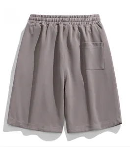 Detail of grey-purple casual shorts featuring elastic waistband and back pocket texture