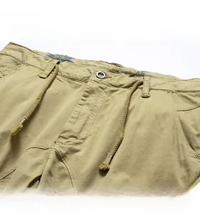 Detail view of khaki cargo shorts with drawstring waist and tropical palm leaf inner lining
