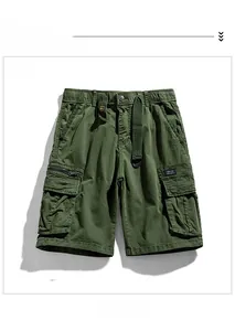 Detailed view of army green cargo shorts featuring elastic waist and utility pockets