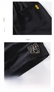 Detail of black ice silk shorts showing NASA logo print and yellow brand pocket tag
