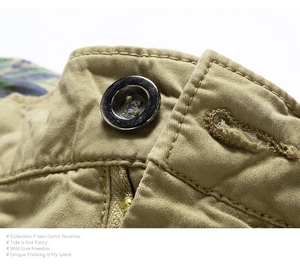 Detail of khaki cargo shorts showing button closure, metal zipper and camouflage lining