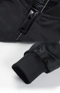 Detail of smooth metal zipper and ribbed cuffs on the black MA1 flight bomber jacket