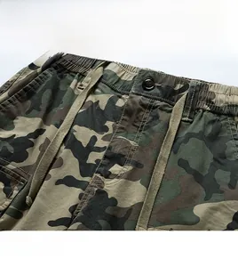 Detail of cargo shorts featuring jungle camo print with elastic drawstring and button fly