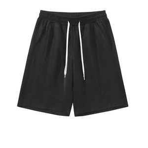 Detail of black sports shorts featuring elastic waistband and white adjustable drawstring