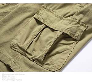 Detailed close-up of large tactical cargo pockets and cotton twill texture on khaki shorts