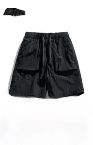 Detail of black ice silk cargo shorts with elastic drawstring waist and large utility pockets