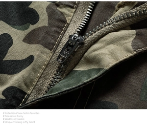 Macro view of high-quality YKK black metal zipper on camo textured cargo shorts