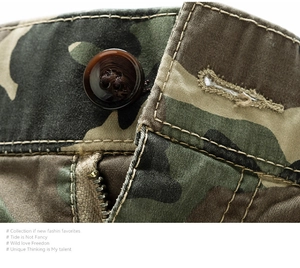 Macro shot of jungle camouflage cargo shorts featuring twill fabric and button closure