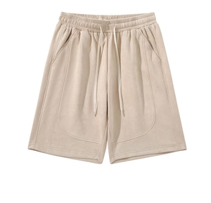 Detail view of beige faux suede shorts showing elastic waist with white drawstring